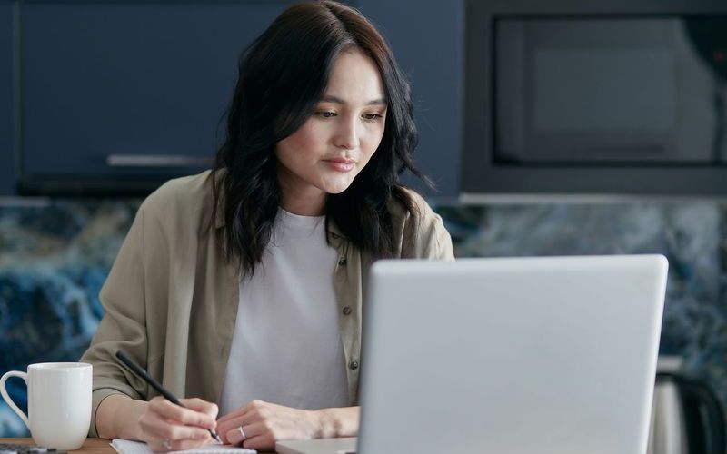 A professional studying at home on a laptop